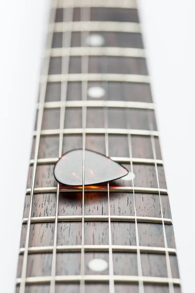 Guitar frets with strings and mediator — Stock Photo, Image