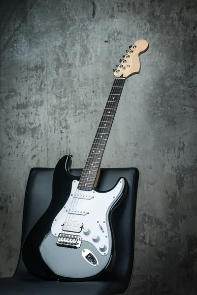 Electric guitar on a chair — Stock Photo, Image