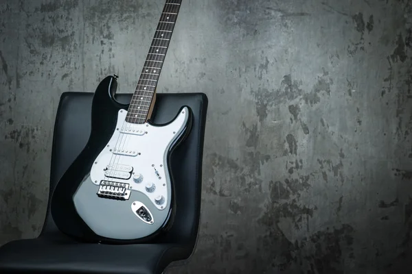 Electric guitar on a chair — Stock Photo, Image