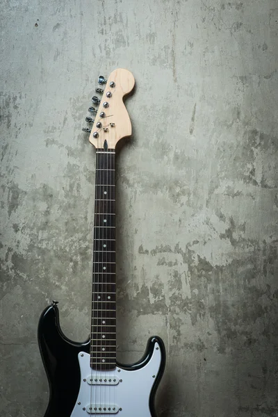 Electric guitar near the concrete wall — Stock Photo, Image