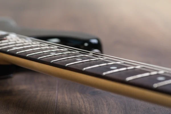 Electric guitar on the wooden floor — Stock Photo, Image