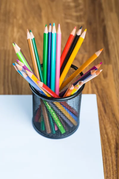 Bunch of color pencils on a white paper sheet — Stock Photo, Image