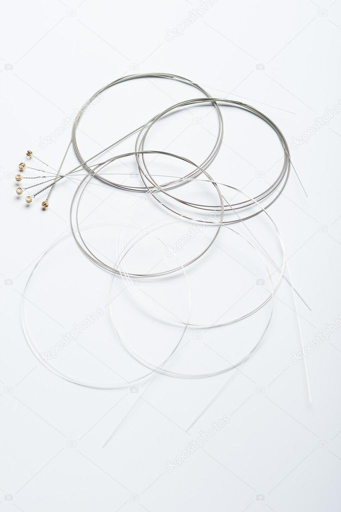 Electric guitar strings on white surface
