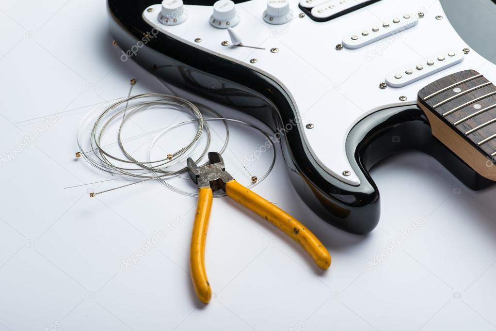 Electric guitar with yellow nippers and strings