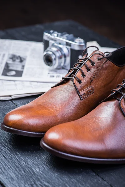 Brown leather shoes on black floor — Stock Photo, Image