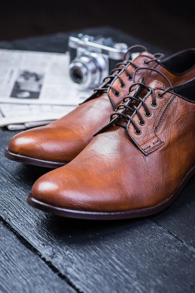 Brown leather shoes on black floor — Stock Photo, Image