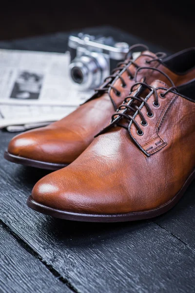 Brown leather shoes on black floor — Stock Photo, Image