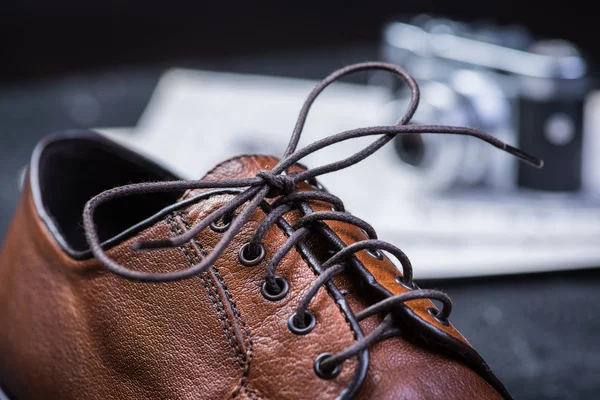 Brown leather shoes on black floor — Stock Photo, Image