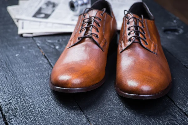 Brown leather shoes on black floor — Stock Photo, Image