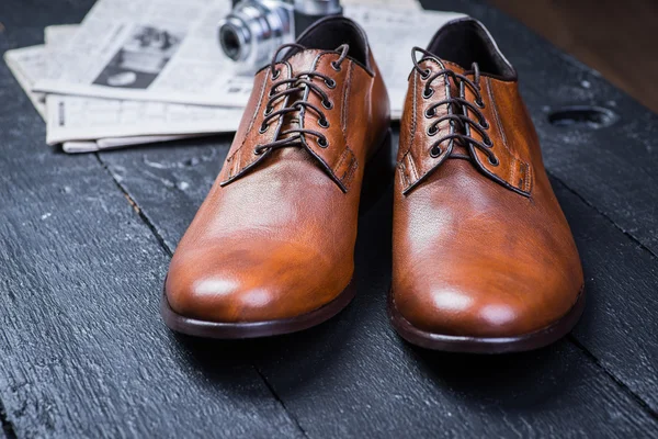 Brown leather shoes on black floor — Stock Photo, Image