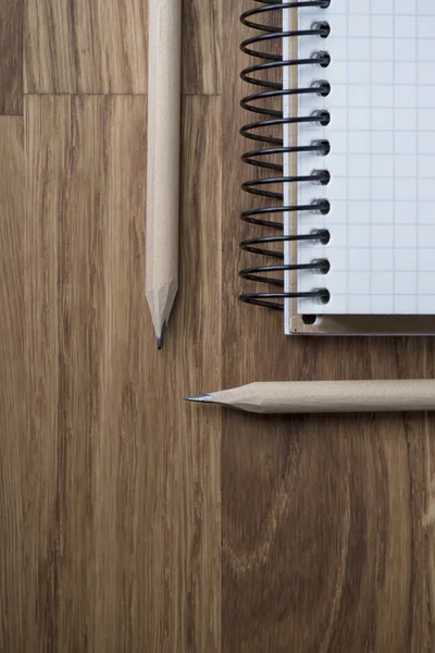 Notebook and pencil on a wooden table — Stock Photo, Image