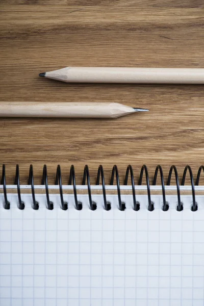 Notebook and pencil on a wooden table — Stock Photo, Image