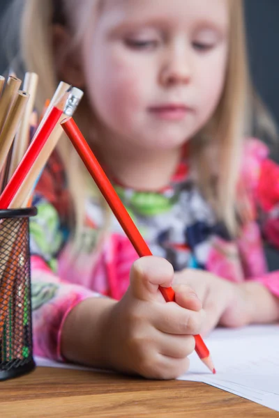 Small young girl drawing pictures with pencils — Stock Photo, Image