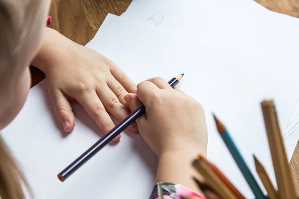 Small young girl drawing pictures with pencils — Stock Photo, Image