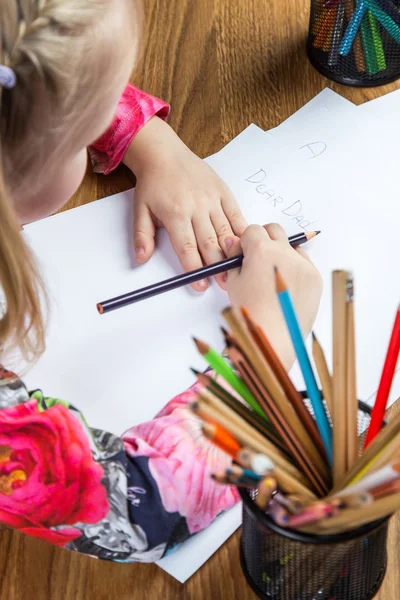 Small young girl drawing pictures with pencils — Stock Photo, Image