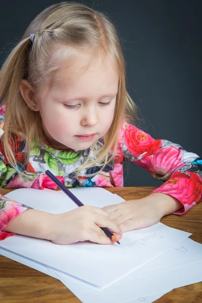 Small young girl drawing pictures with pencils — Stock Photo, Image