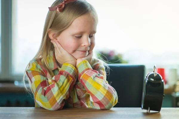 Young little hipster looking girl with alarm clock — Stock Photo, Image