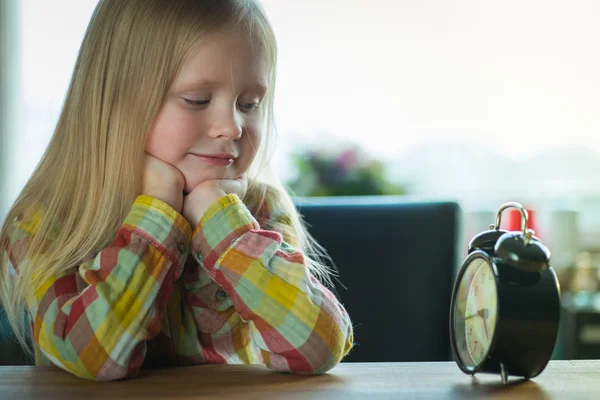 Young little hipster looking girl with alarm clock — Stock Photo, Image