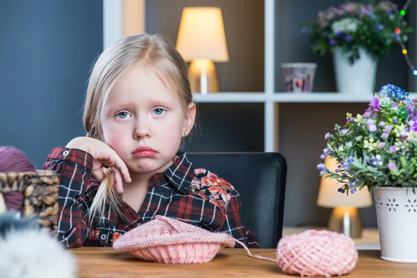 Cute little girl knitting a vintage style woolen hat — Stock Photo, Image