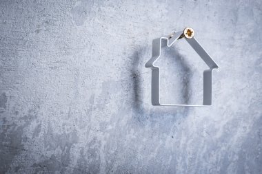 Metal ev gri beton duvarındaki vida asılı