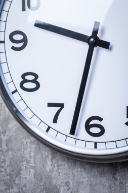 Gri beton duvara asılı yuvarlak duvar saati