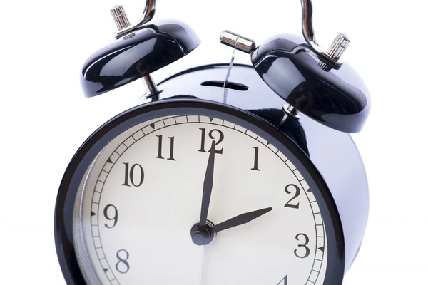 Black vintage alarm clock over the white background — Stock Photo, Image