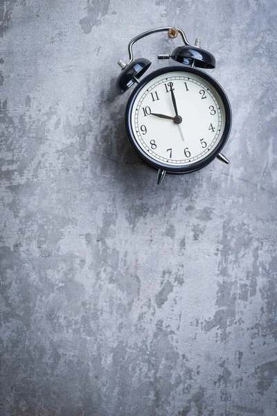 Unusual picture of vintage alarm clock hanging on the wall — Stock Photo, Image
