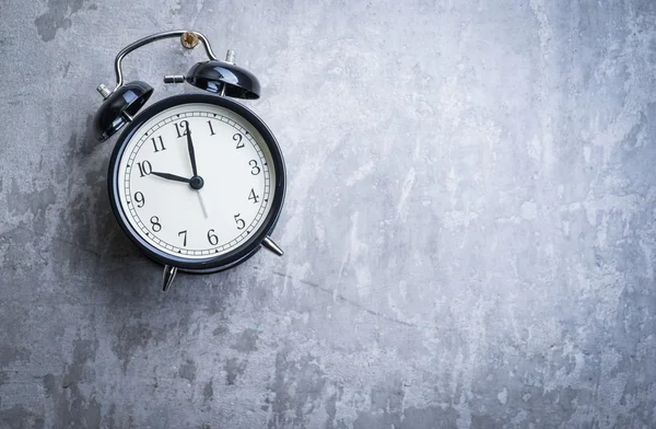 Unusual picture of vintage alarm clock hanging on the wall — Stock Photo, Image