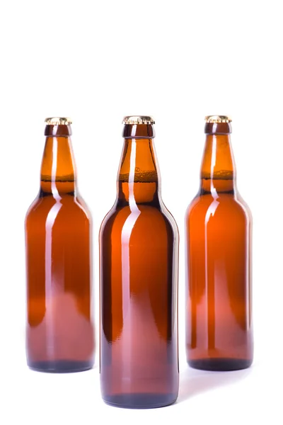 Üç beyaz izole buz gibi bira şişesi — Stok fotoğraf
