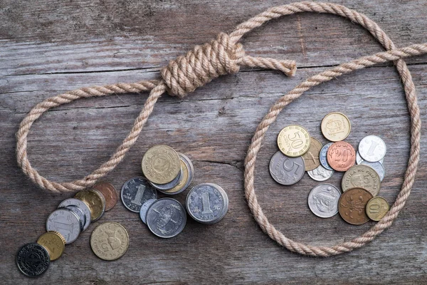 Hangman's noose with money on brown wooden surface — Stock Photo, Image