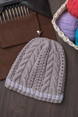 Handmade knitted hat with knitting accessories