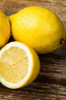 Fresh and juicy lemons and lime on a wooden surface