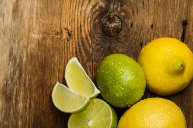 Fresh and juicy lemons and lime on a wooden surface