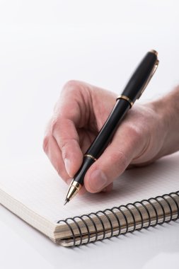 Man writing a note with black ball pen in his hand, isolated