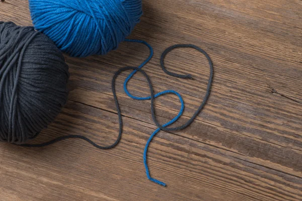 Two balls of knitting yarn on wooden surface — Stok fotoğraf