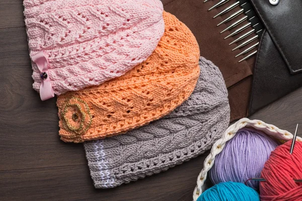 Handmade knitted hats with knitting accessories Stock Fotografie