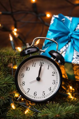 Sunni Noel ağacı, hediyeler, ışıklar ve saatin üzerine ahşap duvar