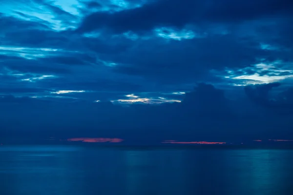 Pôr do sol de verão na praia com nuvens sobre o céu — Fotografia de Stock