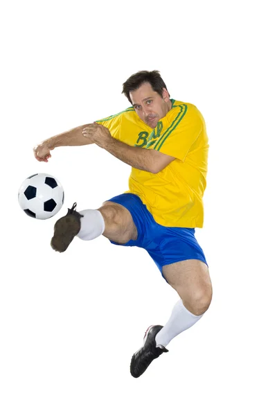 Brazilský fotbalista, skákání, žluté a modré — Stock fotografie