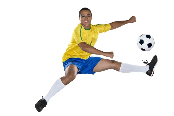 Jogador brasileiro de futebol, saltando, amarelo e azul — Fotografia de Stock