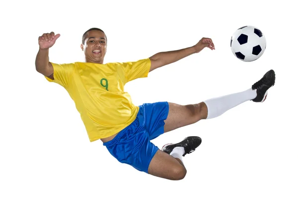 Jogador brasileiro de futebol, saltando, amarelo e azul — Fotografia de Stock