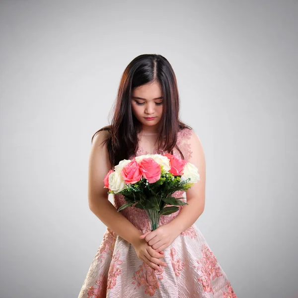 Sad girl with bunch of roses — Stock Photo, Image