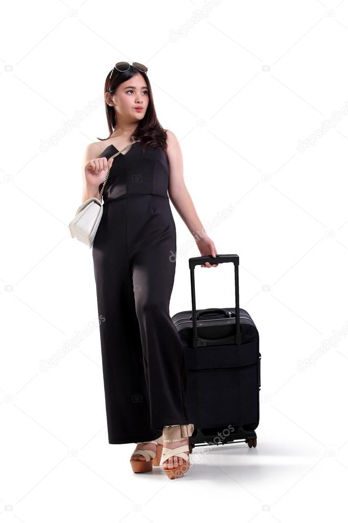Attractive woman walks with travel bag, full body shot