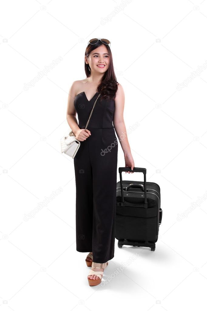 Beautiful traveling woman with suitcase, full body shot