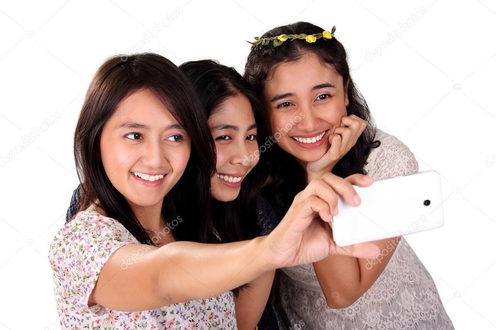 Three women selfie with front camera isolated