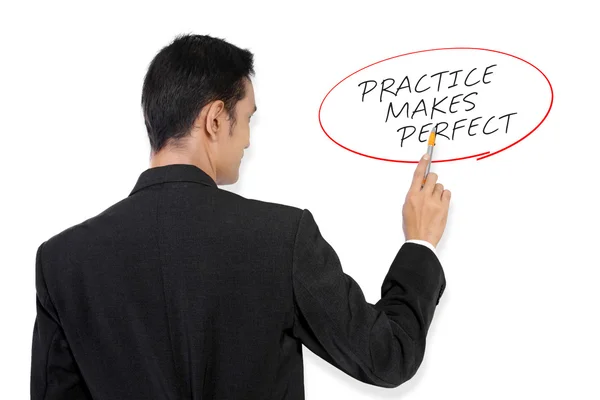 Empresario señalando "La práctica hace perfecto " —  Fotos de Stock