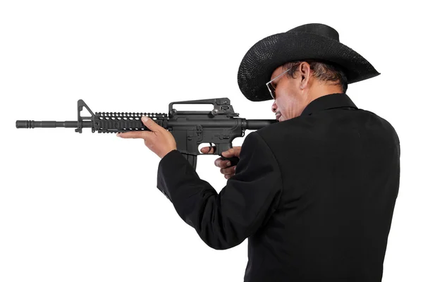 Man in black shooting with rifle — Stock Photo, Image