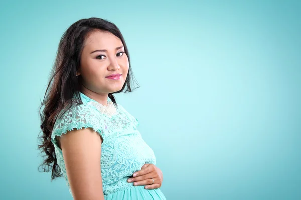 Happy woman during pregnancy, mint colored copyspace — Stock Photo, Image