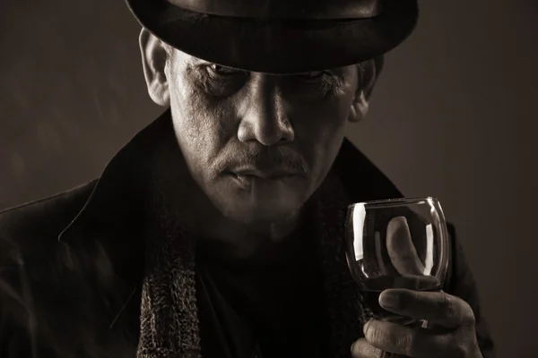 Old gangster and a glass of wine — Stock Photo, Image