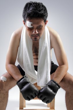 Exhausted fighter sitting on chair